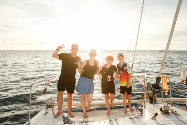 Family with sunset on the catamaran