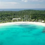 Aerial view of Patok Bay at Racha Island Phuket with clear turquoise water and white sand beach