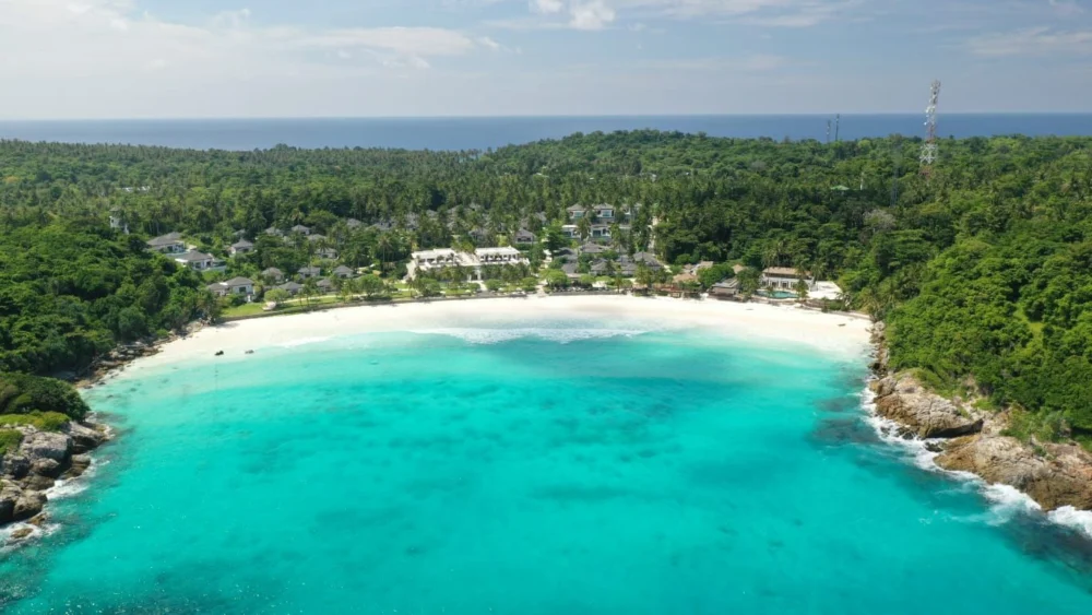 Aerial view of Patok Bay at Racha Island Phuket with clear turquoise water and white sand beach