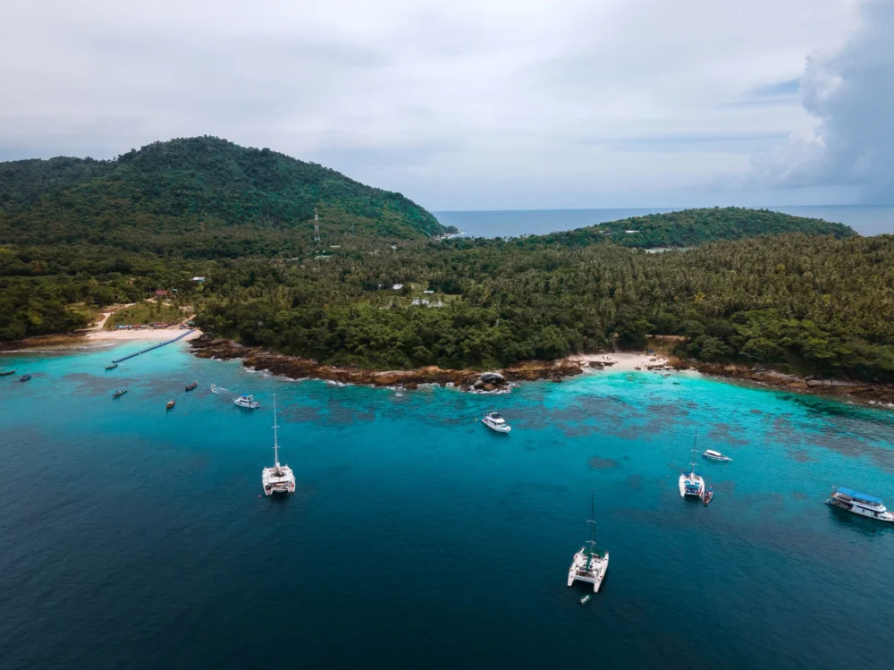 Aerial view of Ter Bay and Lah Bay at Racha Island used for rainy season snorkeling and boat landing