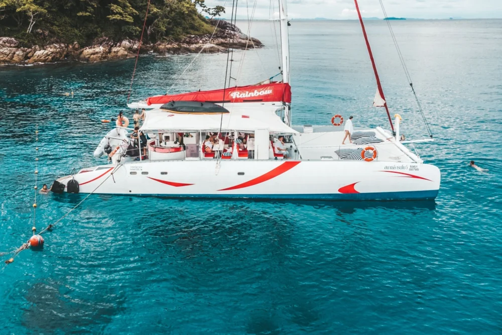 Smile Rainbow Catamaran at Coral Island with clear blue water