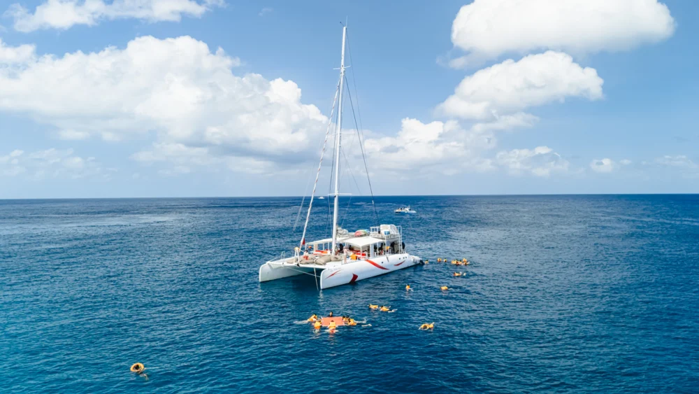 Guests snorkeling from Smile Rainbow Catamaran around Racha Island