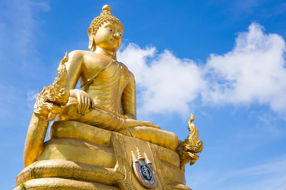 Golden Buddha image beside the main white Big Buddha in Phuket