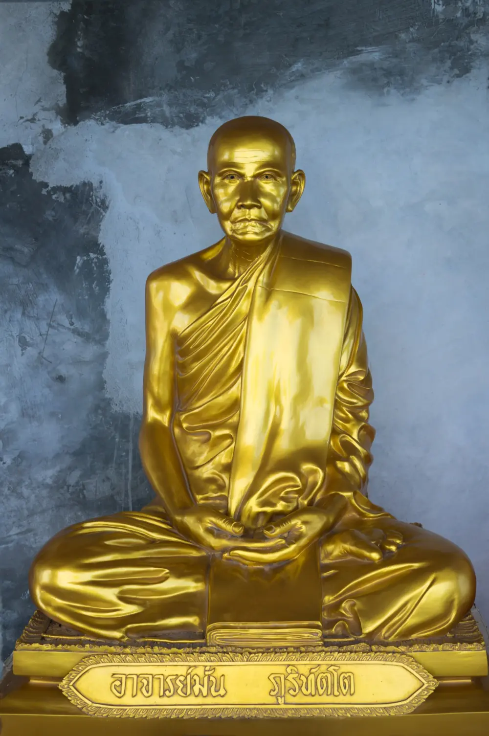 Golden Buddhist statues beneath the Big Buddha Phuket monument