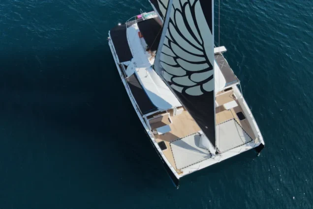 Black Wing Catamaran aerial view cruising on the sea in Phuket