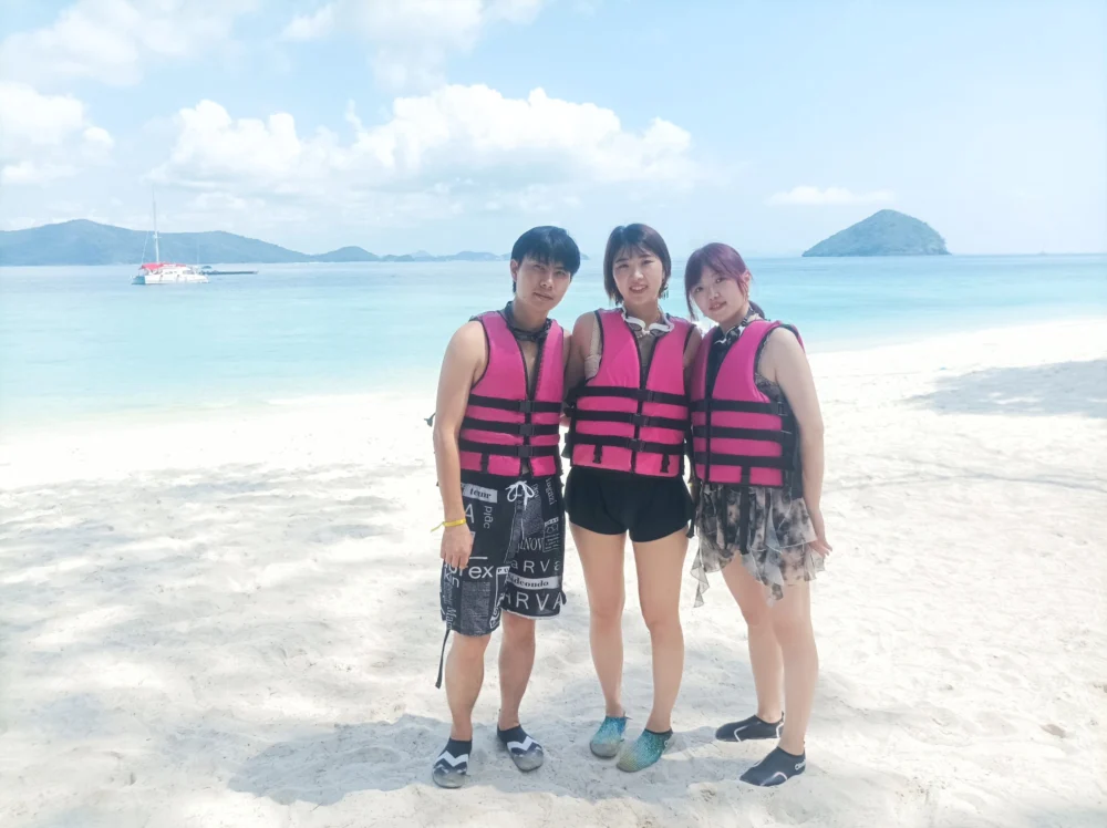Family group standing on the beach at Coral Island Phuket