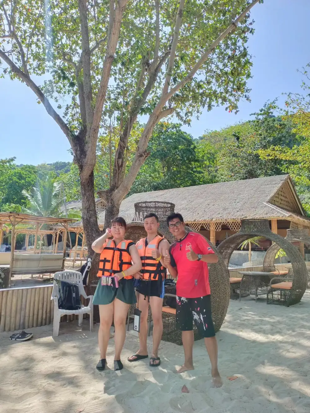 Phuket tour guide taking a photograph with Chinese travelers at Coral Island