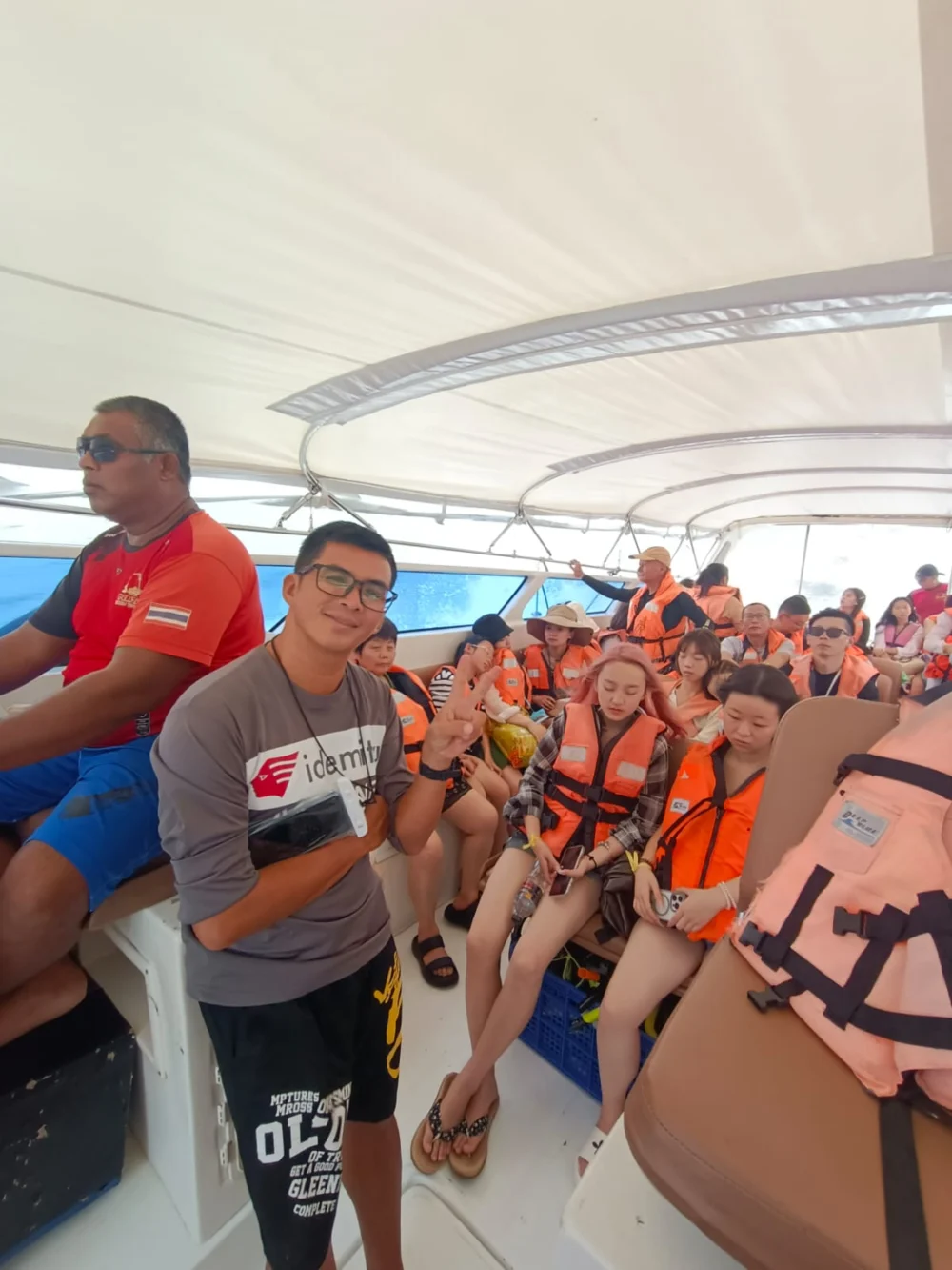 Tour guide and traveler preparing for a Phuket island trip inside a speedboat