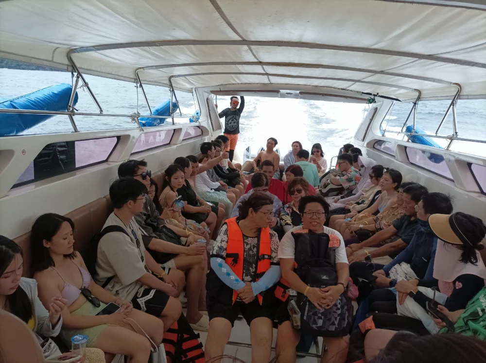 Passengers traveling by speedboat across the sea toward Racha Island