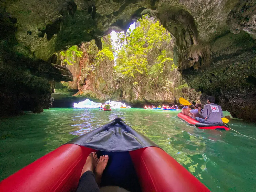 Sea canoe entering a limestone cave near Hong Island in Phang Nga Bay