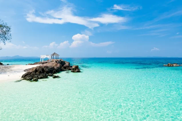 White-sand coastline and blue water at Maithon Island