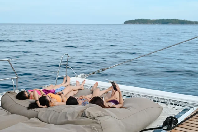 Guests relaxing on the spacious forward lounge of Noah Catamaran