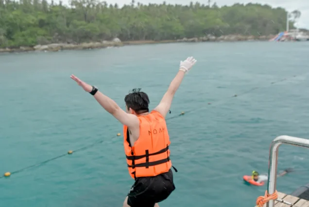 Guest jumping from Noah Catamaran into the sea