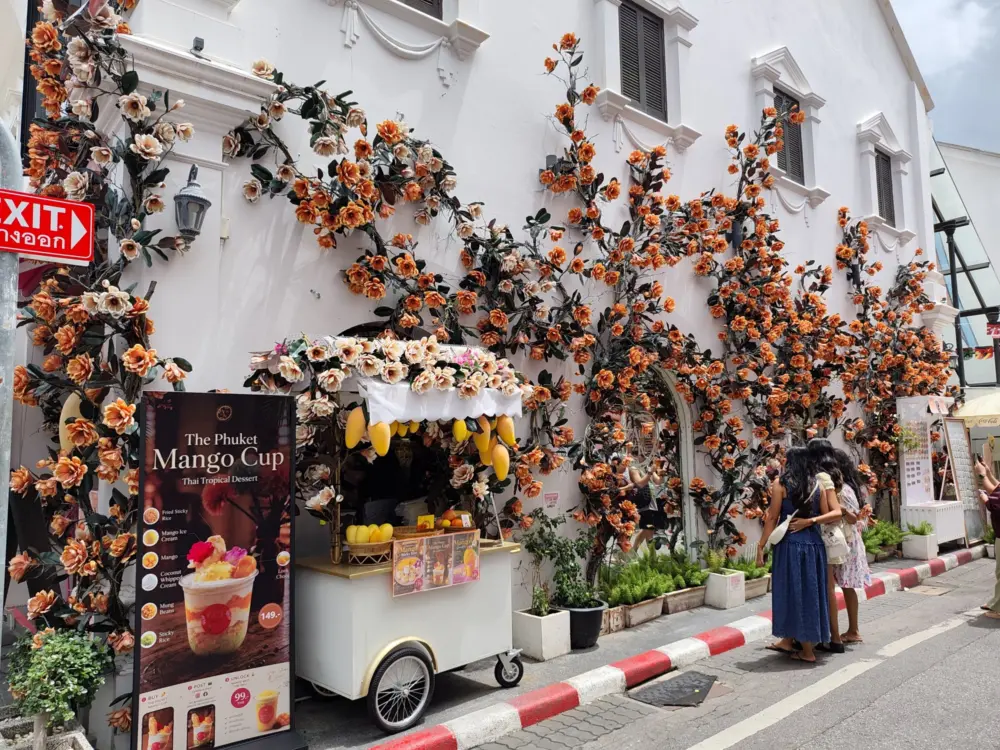 Soi Romanee in Phuket Old Town with colorful wall decorations and flowers