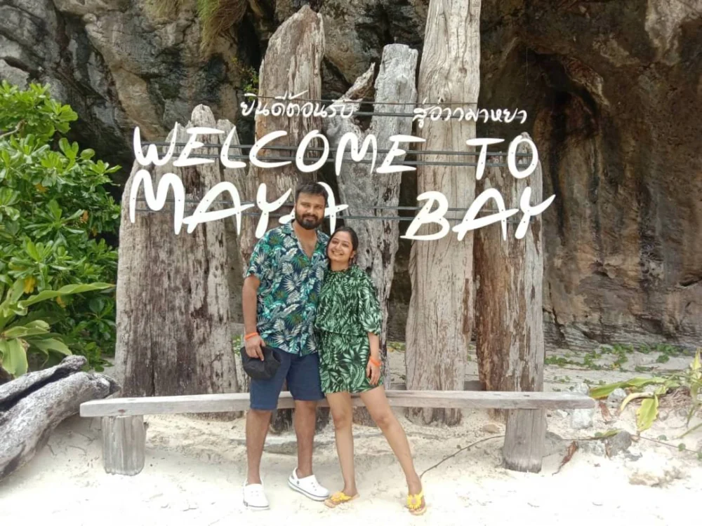 Travelers at the Maya Bay sign during a Phi Phi Island day trip