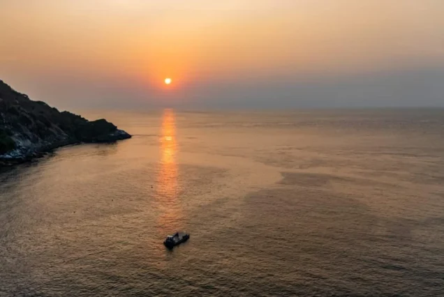 Sunset view over the sea with boat near Racha Island