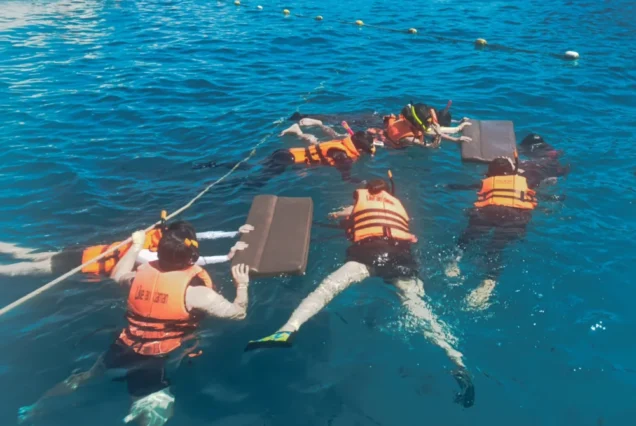 Traveler snorkeling in clear water at Lah Bay on Racha Island