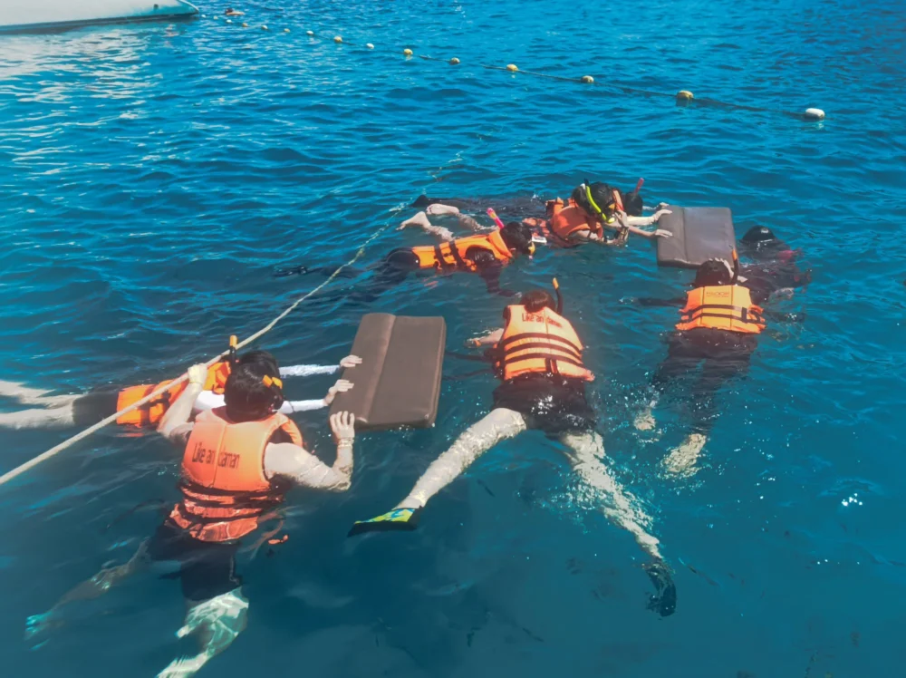 Traveler snorkeling in clear water at Lah Bay on Racha Island