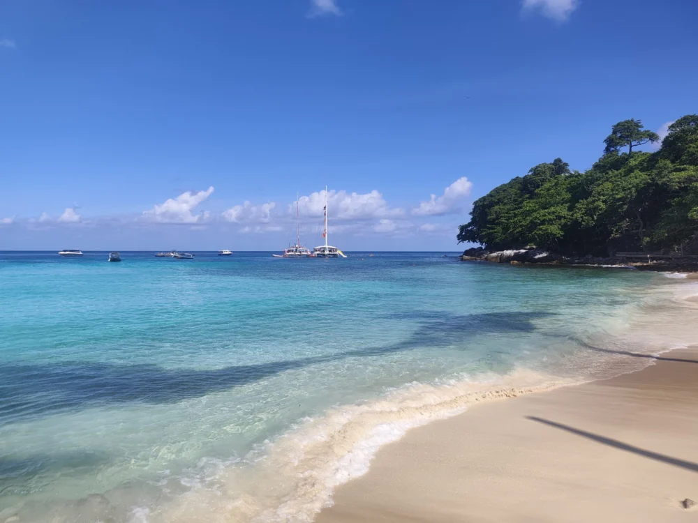 Ter Bay pier at Racha Island during rainy season with clear water