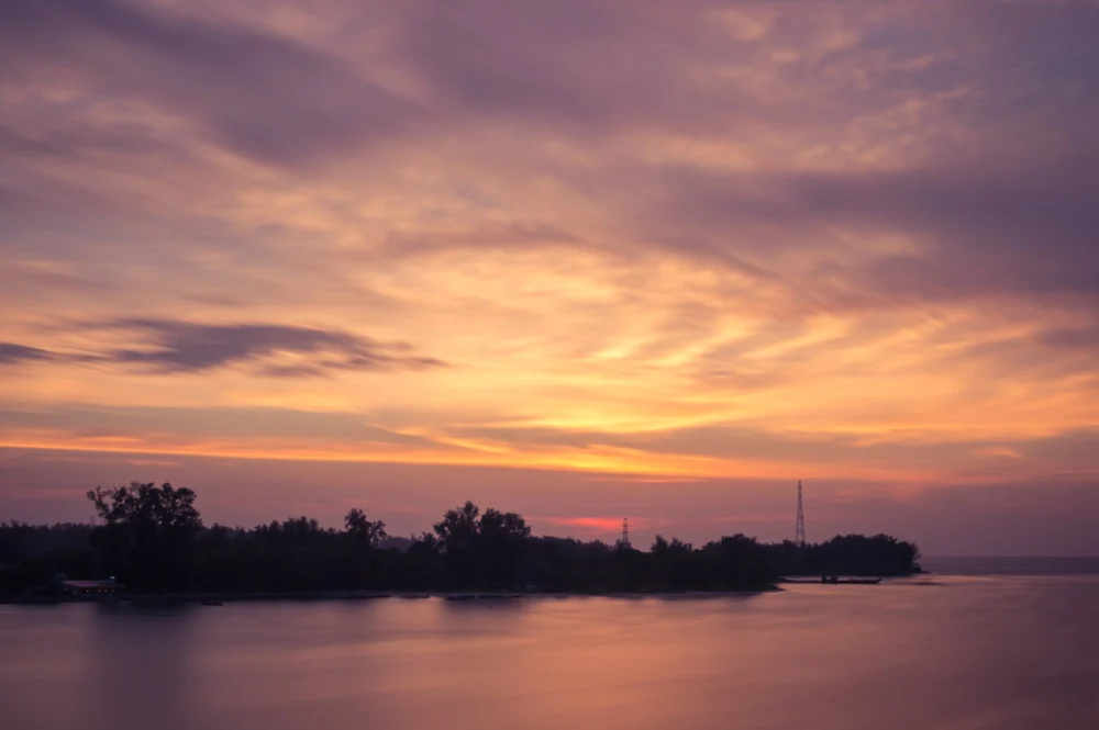 Sunset over the sea beside Sarasin Bridge in northern Phuket
