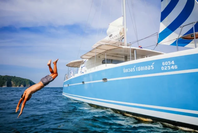 Guest jumping from Silver Catamaran into the sea during Phuket island tour