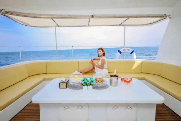 Guest sitting on the large sofa inside Silver Catamaran