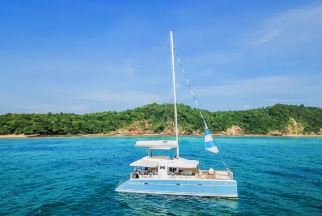 Aerial side view of Silver Catamaran cruising in Phuket