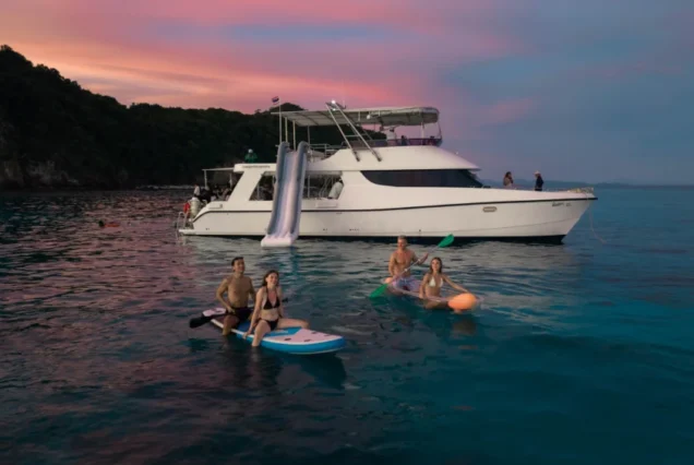 Paddleboard clear kayak and water slide activities beside Moonlight Catamaran