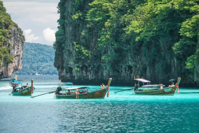Long-tail boat in the clear water of Pileh Lagoon