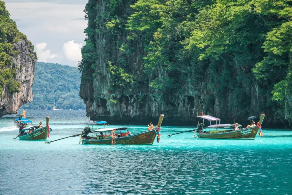 Long-tail boat in the clear water of Pileh Lagoon