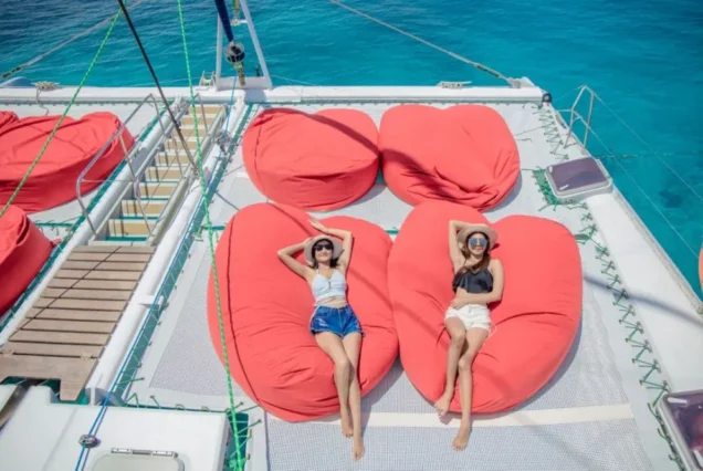 Upper-deck lounge sofa above the Aquaman trampoline net
