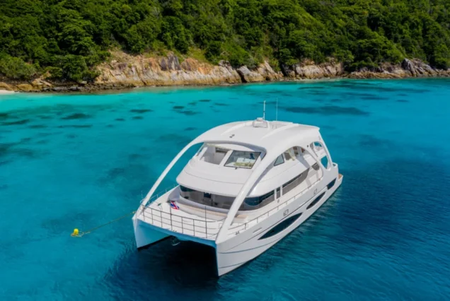 Flying Dolphins 1 luxury yacht anchored in a clear tropical bay