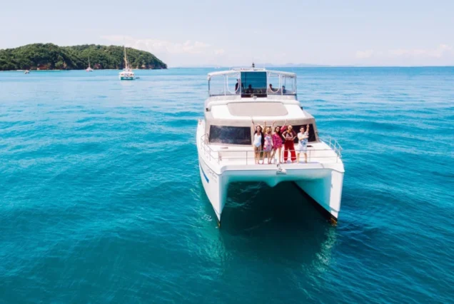 Indigo Catamaran Yacht approaching a tropical island bay