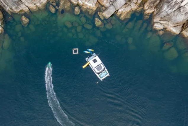 Aerial view of Indigo Catamaran Yacht and a small boat