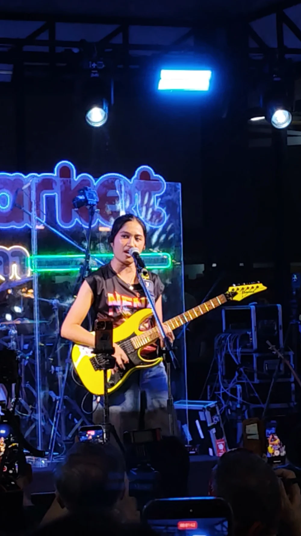 Nene Royal performing with her yellow guitar at Naka Market on 12 September 2026