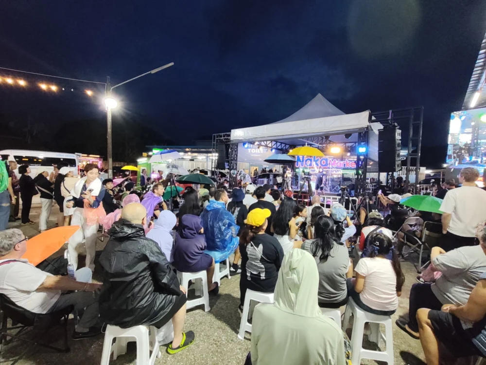 Audience waiting in the rain before Nene Royal performed at Naka Market Phuket