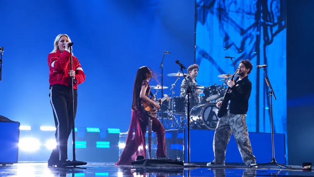 Nene Royal playing guitar alongside Linkin Park on the AGT stage