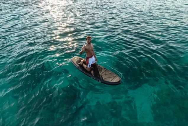 Paddle activity in the clear waters beside Noah Yacht