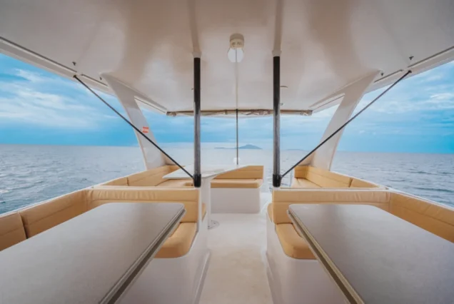 Interior table and sofa seating on Vibes Catamaran