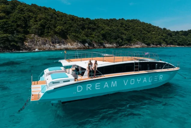 Dream Voyager turquoise catamaran yacht beside an island