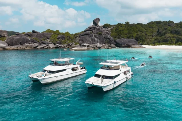 Two Flash No.7 catamaran yachts beside the island shore
