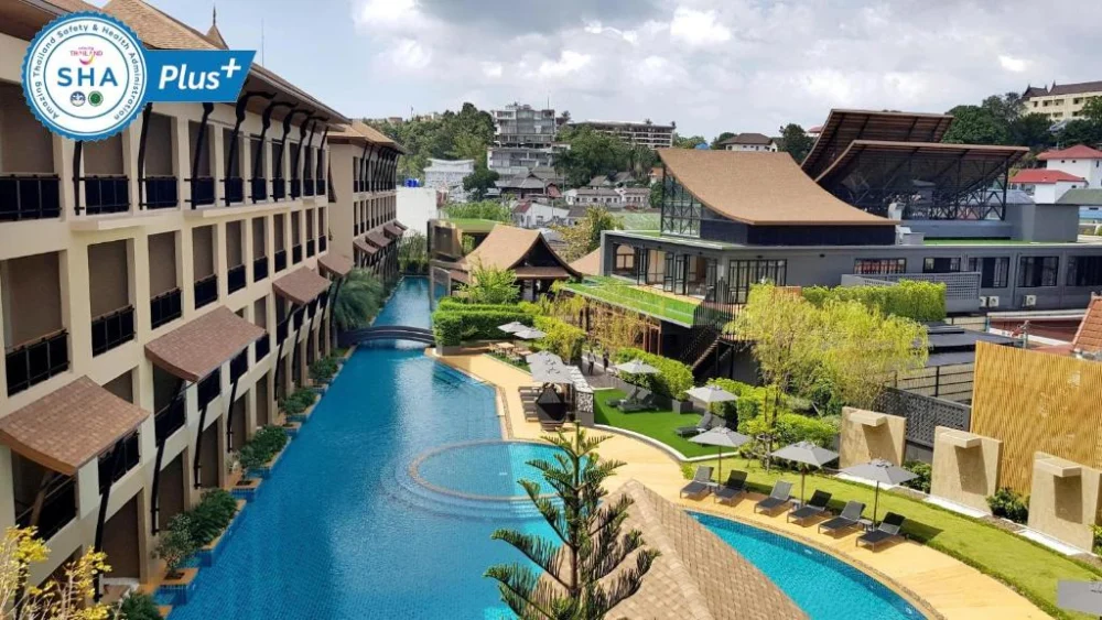 Aurico Kata Resort and Spa buildings surrounding a long blue swimming pool