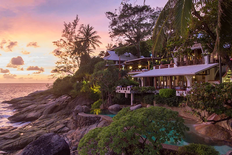 Mom Tri's Kitchen above the rocky shoreline with a warm sunset sky