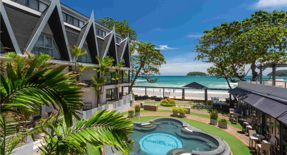 The Boathouse Phuket pool and beachfront buildings facing Kata Beach