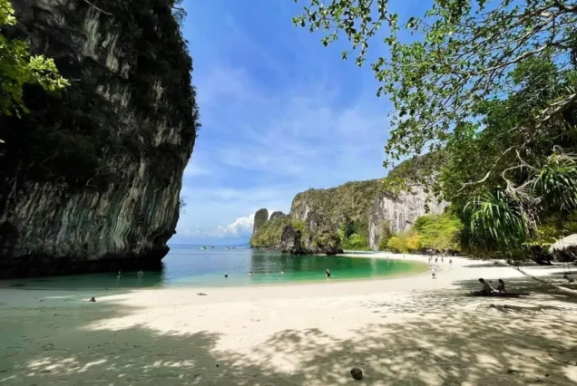 Shaded sandy beach and limestone bay at Lao Lading