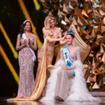 Opal Suchata seated on stage as the Miss World crown is placed on her head
