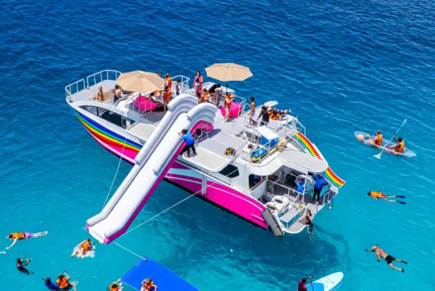 Water slide and paddleboarding beside Seastar Rainbow Catamaran