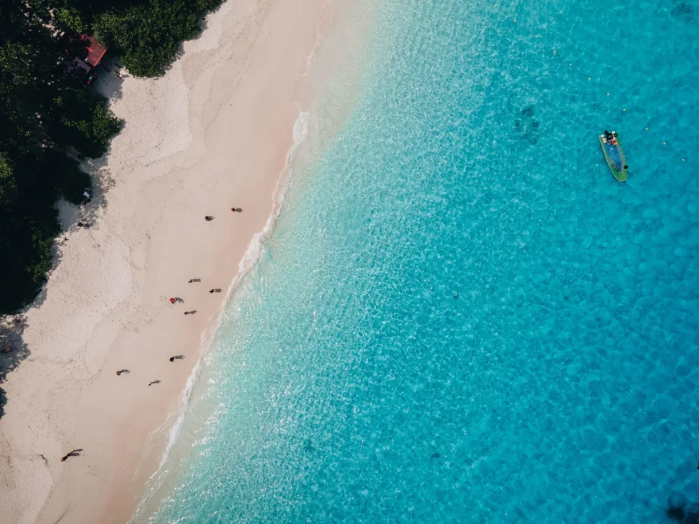 White-sand beach and turquoise coastal water viewed from above in the Similan Islands