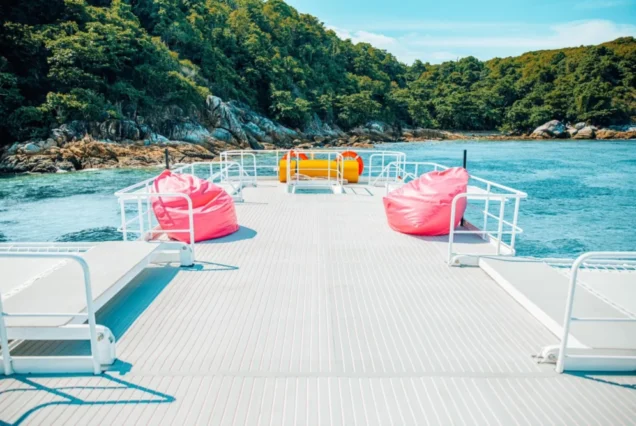 Open upper deck with colorful seats on the Rainbow catamaran