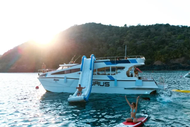 Taurus waterslide and paddleboard activity beside the boat